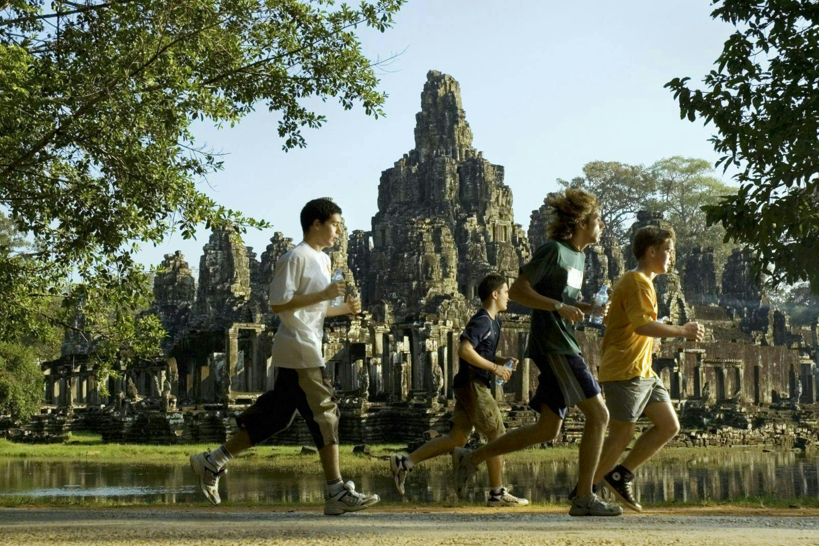 person boy male teen clothing shorts footwear shoe bayon temple landmark